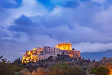 Fototapeta premium Aerial view of the Acropolis Hill, crowned with Parthenon during evening blue hour in Athens, Greece