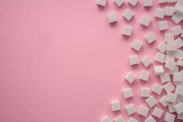 Cubes of sugar on pink background