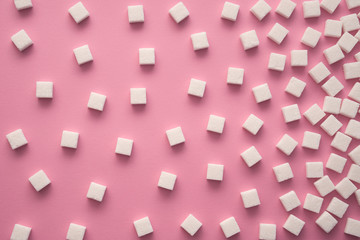 Cubes of sugar on pink background