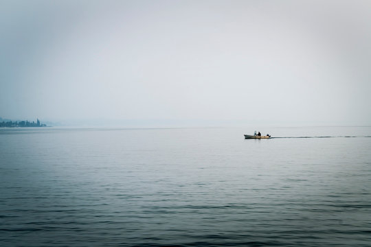 People in distant boat on Lake Garda, Lazise, Veneto, Italy, Europe