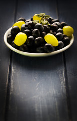 Blueberries and grapes on white bowl