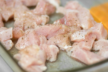 Sliced poultry meat, lying on a baking sheet and ready to bake