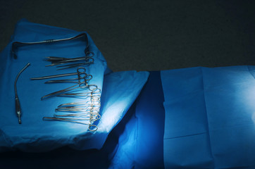 top view of surgical instrument lying on table while group of surgeon work in operation room at hospital, emergency case, surgery, medical technology, health care cancer, disease treatment concept