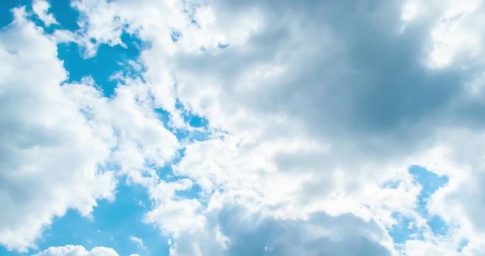 Beautiful cloudscape with large, building clouds and sunrise breaking through cloud mass.