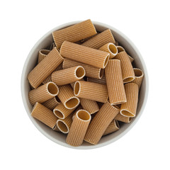 Top view of a bowl filled with tube shaped whole wheat rigatoni isolated on a white background.