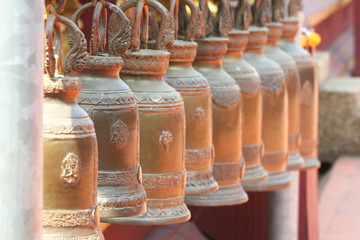Old big brass golden bells hanging at the temple in Thailand