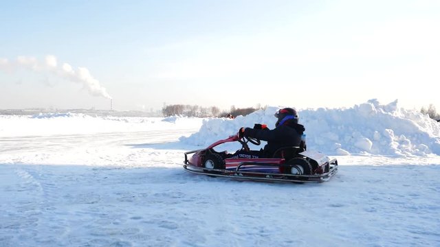 Kart racing on the frozen lake. Winter cart. Riding a go kart in the winter