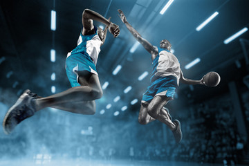 Obraz na płótnie Canvas Basketball player on big professional arena during the game. Basketball player making slam dunk.