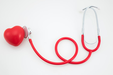 Stethoscope and red heart on white background