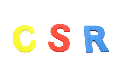 Pastel CSR (Corporate social responsibility) wooden letters on white