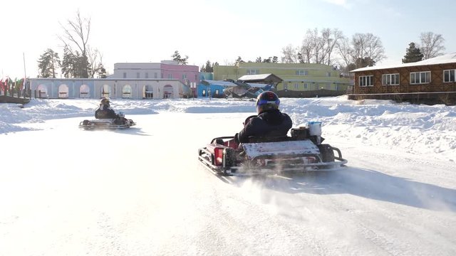 Winter competitions of kart racing on the ice of road. Go kart in winter