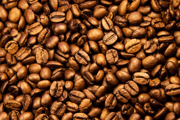Coffee texture. Roasted coffee beans as background wallpaper. Beautiful arabica real cofee bean illustration for any concept. Gourmet coffee beans macro closeup studio photo.