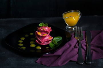 Vegan ravioli with beetroot served with orange sauce