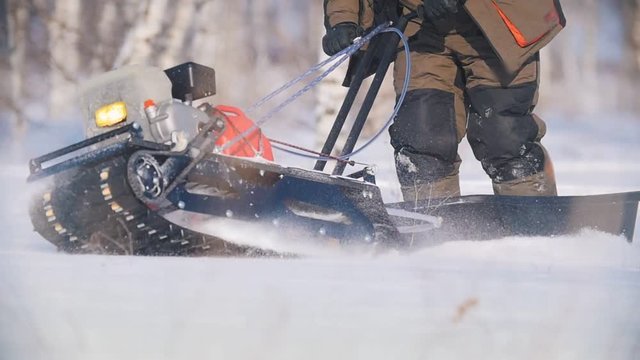 Mini snowmobile overcoming, manoeuvring and turning deep snow