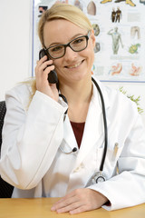 Arzt in Arztpraxis telefoniert bei Telefonberatung oder Telefon-Sprechsstunde