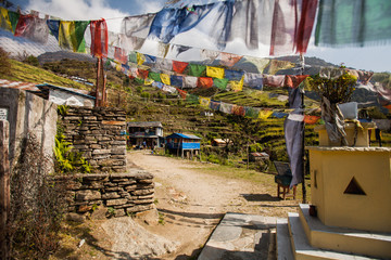 The mountain village in Nepal located on cascades and decorated with traditional Nepal flags. - 193597311