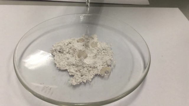 Selective focus on bubble of carbon dioxide from acid drops to Limestone to test calcium in chemical laboratory