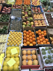 Various fruits on market counter.