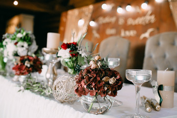 Table decor in a rustic style. Wedding banquet decoration. Artwork. Soft focus on the bouquet