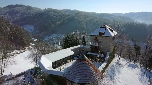 Aerial: Going towards snowy city castle.