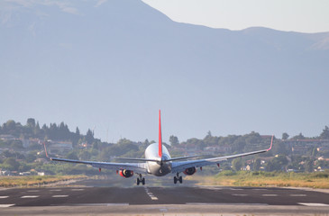 Fototapeta na wymiar Airplane landing on Corfu airport