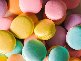 Fototapeta na wymiar Colorful french macarons background, close up.Different colorful macaroons background.Tasty sweet color macaron,Bakery concept.Selective focus.