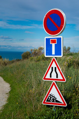 French road signs on a countryside dirt road