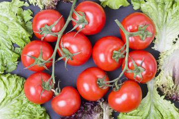 Tomatoes on a black background. Dietary food. Vegetables on a black background. Tomatoes on the table.