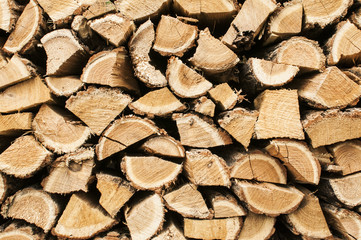 Stacked cut oak firewood closeup as background