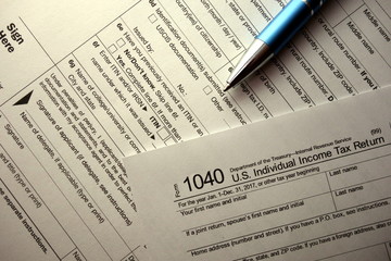 Blank 1040 form and pen, tax day concept