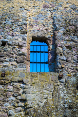 Old stone castle window, clear sky in background. Sky view through old stone castle window, Visegrad, Hungary.  