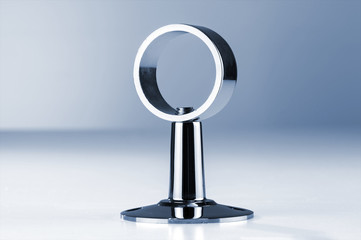 Round steel nickel plated clamp. Installed on a flat surface on a gray background.