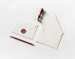 Envelope, seal, stamp and pencil on paper background. Responsive design mockup. Blank stationery....