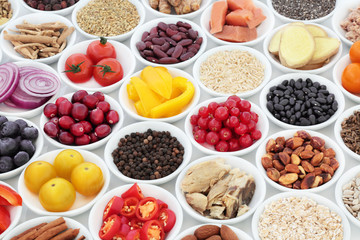 Super food nutrition for a healthy heart high in antioxidants, anthocyanins, fibre, vitamins and minerals with fresh fruit, vegetables, pulses, seeds, nuts, cereals and herbs used in herbal medicine.