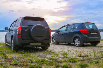 two cars on the shore of the lake