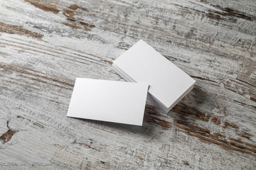 Blank business cards on vintage wooden table background. Responsive design mockup.