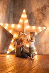 Young Mother and her Child Boy on Studio Background