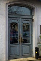 Fototapeta na wymiar Beautiful grey round top vintage doors in an old european city