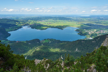Panoramic view at the Kochelsee from Jochberg in the bavarian alpes mountains under blue sky