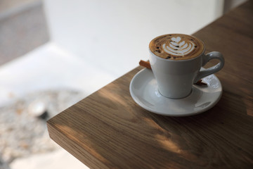 cappuccino or Latte art coffee made from milk on the wood table in coffee shop