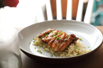 Nasi goreng fried rice with chicken on wood background