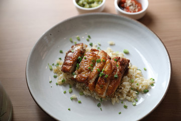 Nasi goreng fried rice with chicken on wood background