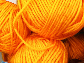 Knitting wool and a woolen ball - as a concept of hobby and creativity handmade. Colored wool thread in a ball for the background