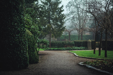 Dark moody park pathway landscape on a wet rainy day