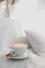 cappuccino or Latte art coffee made from milk on the white table in coffee shop