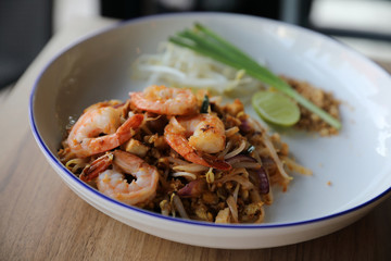 Pad thai with shrimp . Thai food on wood background