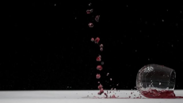 Glass of Merlot Red Wine falls and smashes to the ground. Passion style footage of Easter scenes