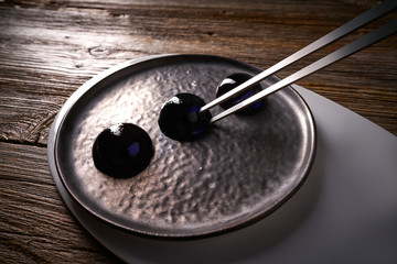 Molecular cuisine concept spheritions in black