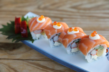 Sushi rolls with salmon on top , Japanese cuisine