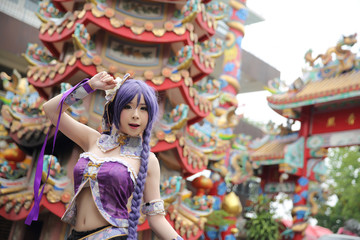 Portrait of asian young woman dancing with purple Chinese dress cosplay with temple